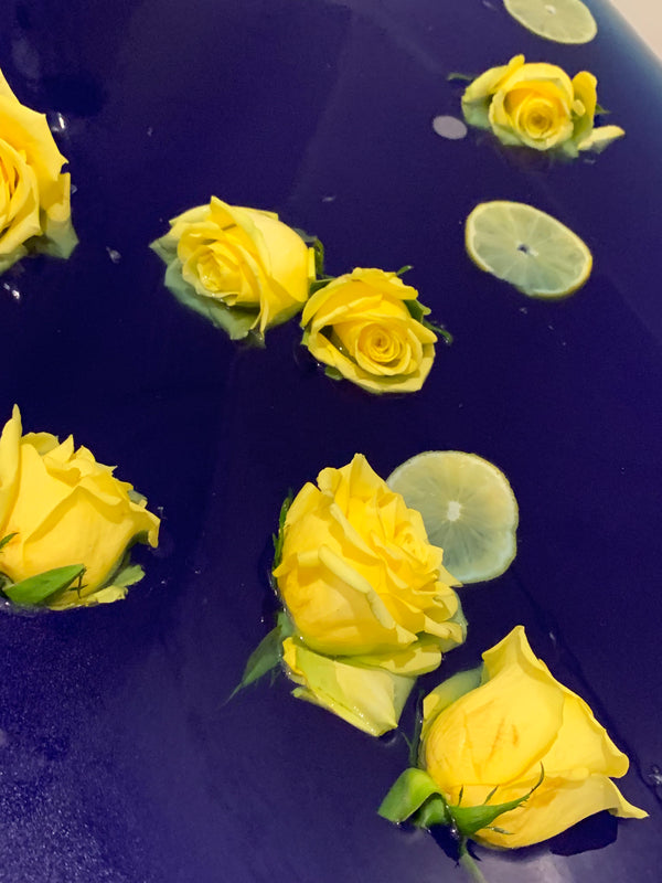 blue bath water with yellow roses