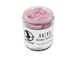 pink sugar scruib packaged in 8 oz glass jar with a white label that reads: 11:11 Body Scrub. Cherry Blossoms & Rose. 