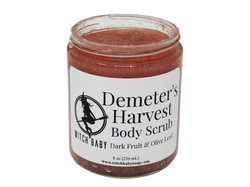 jam colored body scrub in an 8 oz glass jar with a white label that reads: demeter's harvest body scrub. dark fruit & olive leaf.