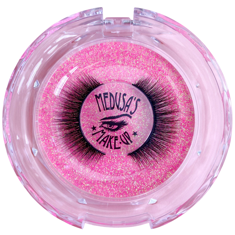 Pink glittery container with false eyelashes branded 'Medusa's Make Up' on a white background