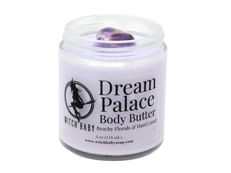 purple body butter in 4 oz glass jar topped with amethyst with clear label that says Dream Palace Body Butter. Beachy Florals & Hard Candy. 