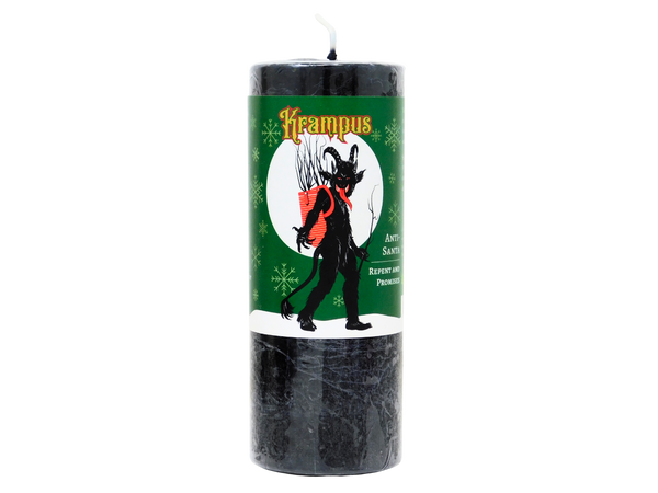 Black candle with a green label featuring Krampus design on a white background