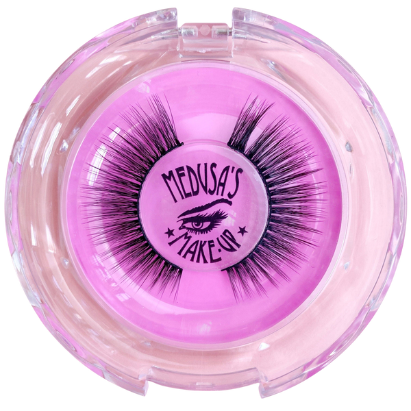 Pink container with false eyelashes branded 'Medusa's Make-Up' on a white background