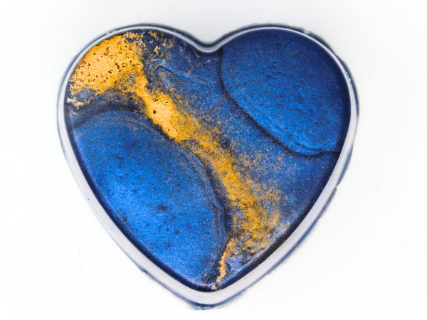 dark blue heart shaped soap topped with gold himalayan salt