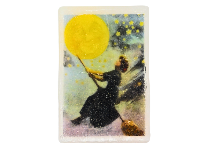 Bar of soap with an illustration of a person in a night dress holding a moon with stars around, against a white background.