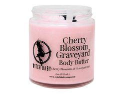 pink body butter in glass jar with clear label that reads Cherry Blossom Graveyard Body Butter. Cherry Blossoms & Graveyard Dirt. 