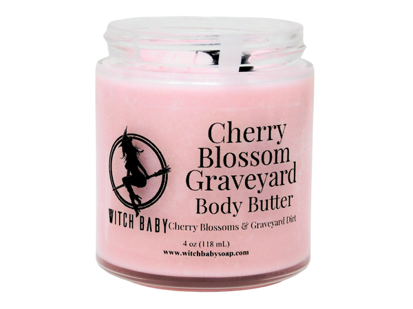 pink body butter in glass jar with clear label that reads Cherry Blossom Graveyard Body Butter. Cherry Blossoms & Graveyard Dirt. 