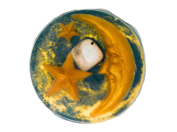 circular forest green soap with gold stars and moons, a crystal, and gold glitter
