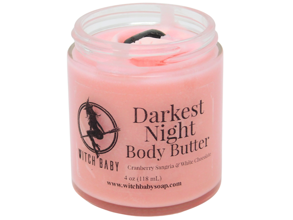 4 oz glass jar filled with pink body butter and topped with tumbled garnet. clear label reads: darkest night body butter. cranberry sangria & white chocolate.