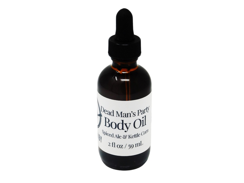 2 oz brown glass dropper bottle with white label that reads: Dead Man's Party Body Oil. Spiced Ale & Kettle Corn.