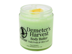 pastel green body butter in 4 oz glass jar with a clear label that reads: Demeter's Harvest Body Butter. Dark Fruit & Olive Leaf. 