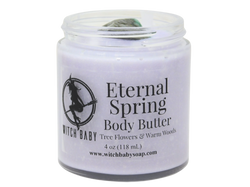 purple body butter in glass jar with clear label that reads: eternal spring body butter. tree flowers & warm woods. 