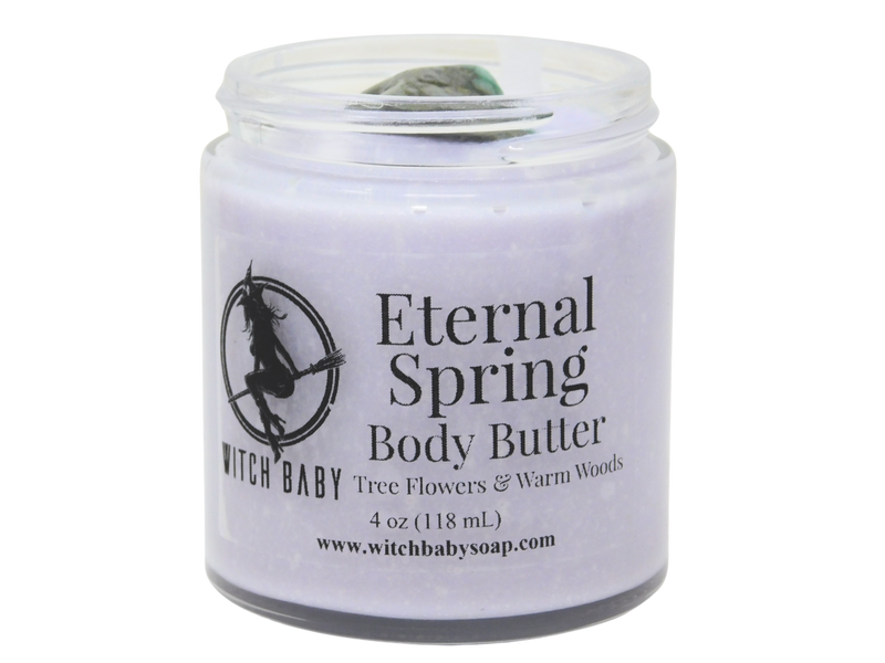 purple body butter in glass jar with clear label that reads: eternal spring body butter. tree flowers & warm woods. 