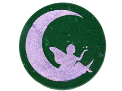 dark green circular bath bomb with pink glittery airbrush of a fairy on the moon
