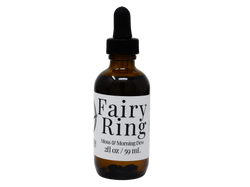 brown glass bottle of body oil that says fairy ring. moss& morning dew. 
