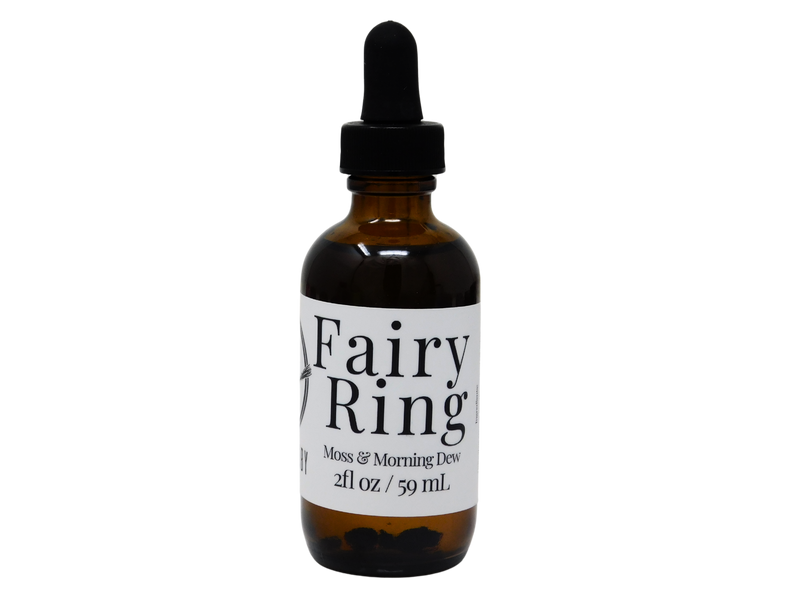 brown glass bottle of body oil that says fairy ring. moss& morning dew. 
