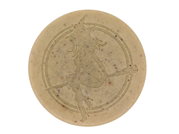 round beige soap stamped with witch and speckled with herbs