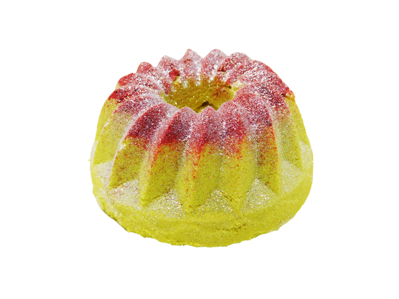 yellow bundt cake bath bomb with strawberry and glitter on top