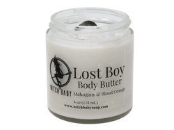 grey body butter in 4 oz glass jar topped with bloodstone. packaged with clear label that reads: Lost Boy Body Butter. Mahogany & Blood Orange. 