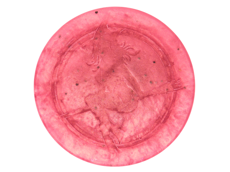 pink circular soap withi black seeds and witch baby logo on top