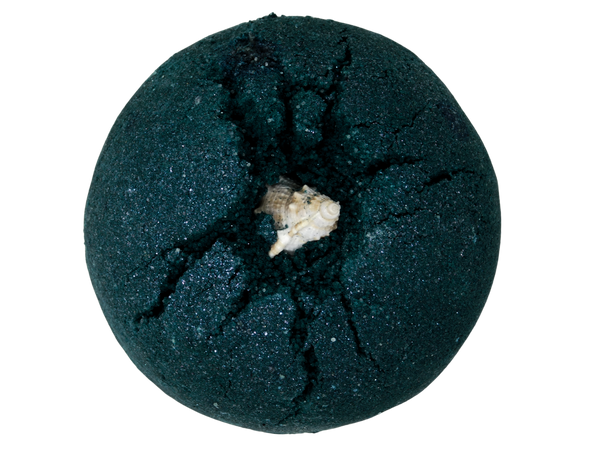 black sparkly bath bomb with a seahell on top
