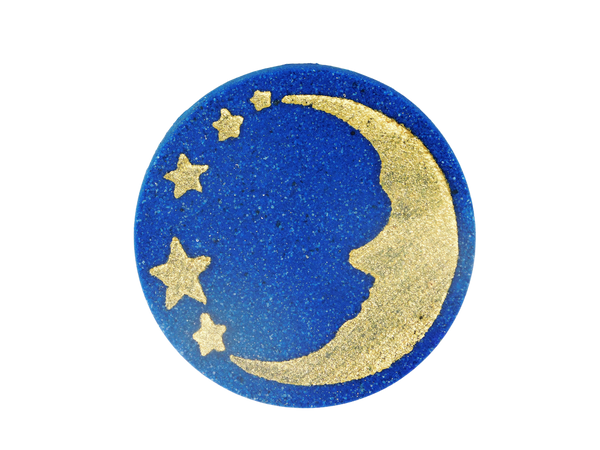 blue puck bath bomb with a gold moon and stars on top
