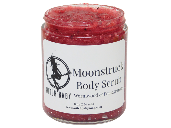 jam red scrub full of berry seeds packaged in an 8 oz glass jar with a white label that reads: Moonstruck Body Scrub. Wormwood & Pomegranate.