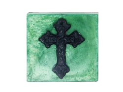 square shaped emerald green shimmering soap with a black gothic cross on top