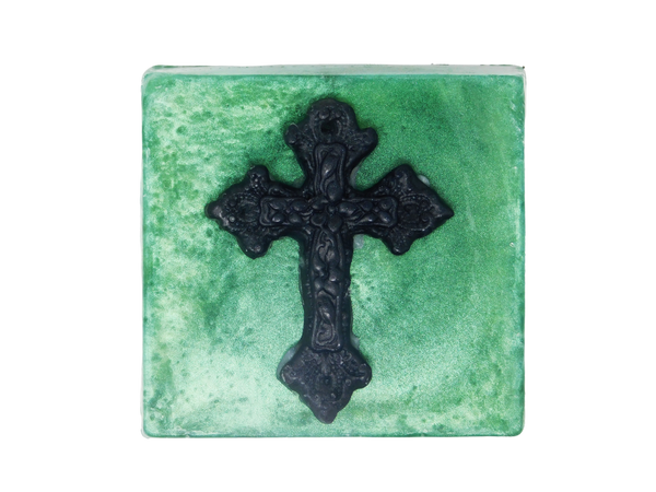square shaped emerald green shimmering soap with a black gothic cross on top