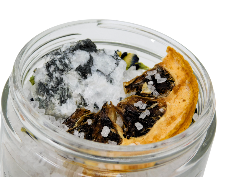 close up of lemon and moonstone on top of Salt of the Moon Bath Salt.