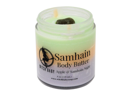 green, orange, and purple  colored body butter topped with smoky quartz with clear label that says Samhain Body Butter. Apple & Samhain Night. 