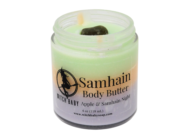 green, orange, and purple  colored body butter topped with smoky quartz with clear label that says Samhain Body Butter. Apple & Samhain Night. 