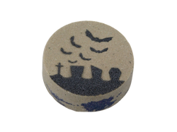 gray bath bomb with graveyard scene and purple at the center of the bath bomb