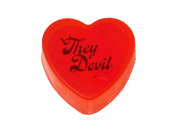 clear red heart soap with 'they devil' on top styled in a devilish font