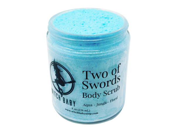 aqua blue shimmering thick moisturizing body scrub with clear lbale that reads: Two of Swords Body Scrub. Aqua - Jungle - Floral.