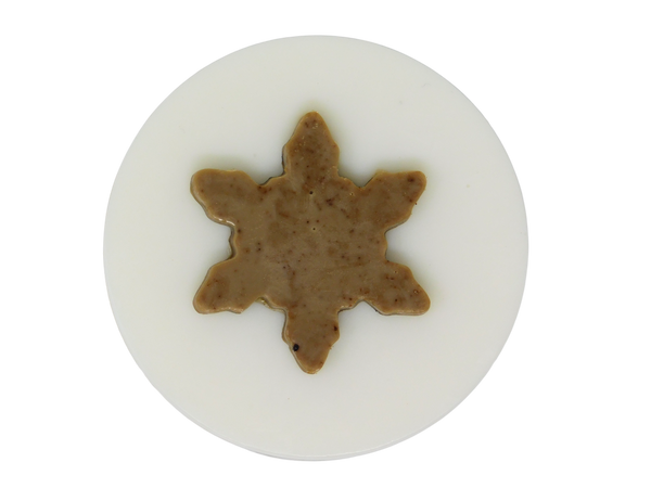 circular white soap topped with coffee colored and speckled snowflake