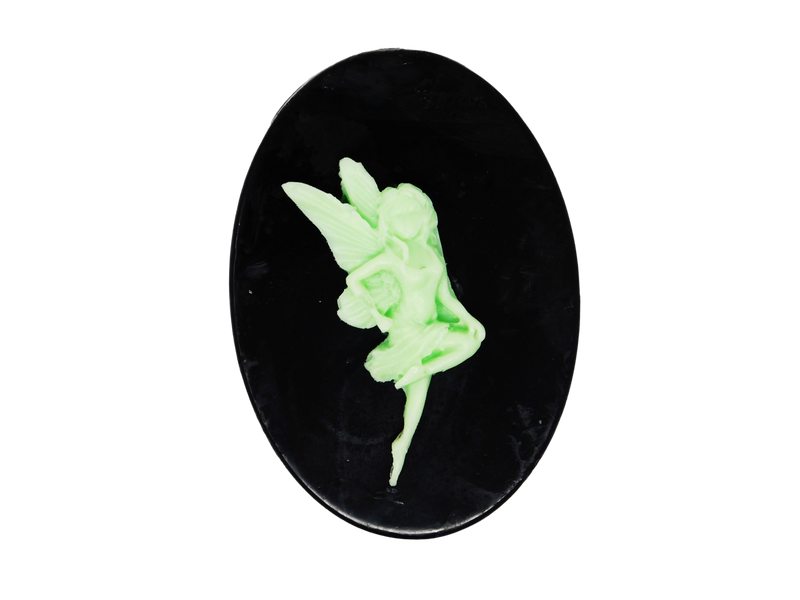 black oval shaped soap with light green fairy in a different pose on top
