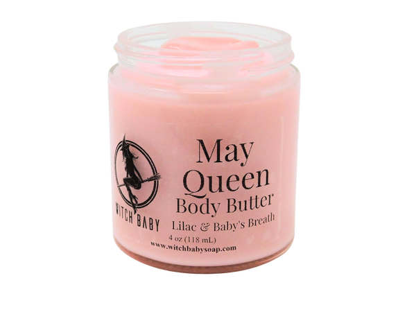 pink body butter packaged in a 4 oz glass jar with a clear label that reads May Queen Body Butter. Lilac & Baby Breath.