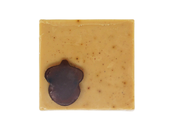 light brown coffee speckled square soap  with dark brown acorn shaped soap on top