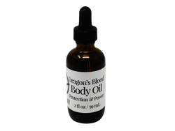 2 oz glass dropper bottle in amber color with label that says dragons blood body oil. Protection and power. 