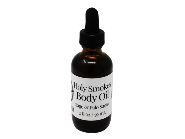 2 oz amber colored glass dropper bottle with label that say holy smokes body oil sage and palo santo