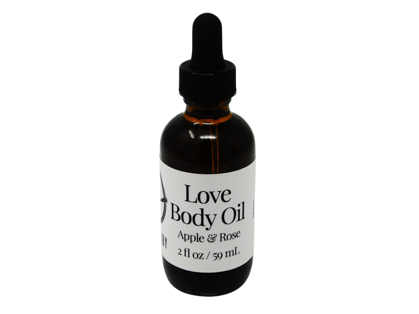brown glass dropper bottle with label that reads: Love Body Oil. Apple & Rose. 