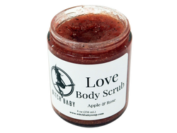 8oz glass jar containing red colored scrub with small black seed. Label says Love body scrub apple and rose. 
