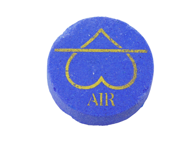 dark periwinkle circle bath bomb with air symbol in gold on it in the shape of a heart instead of a triangle and it says AIR beneath it