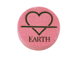 pink circular bath bomb with the symbol of the earth element (but fashioned to be a heart instead of a triangle) and the word EARTH airbrushed at the bottom in dark green glitter