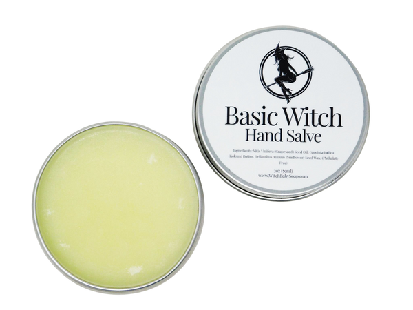 Circular tin containing hand salve. Label says Basic Witch Hand Salve. 