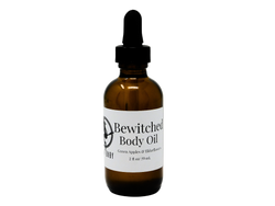 Bewitched Body Oil packaged in a 2 oz glass dropper bottle with a white label that reads: Bewitched Body Oil. Green Apples & Elder Flowers. 