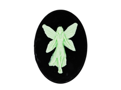 black oval shaped soap with light green fairy on top