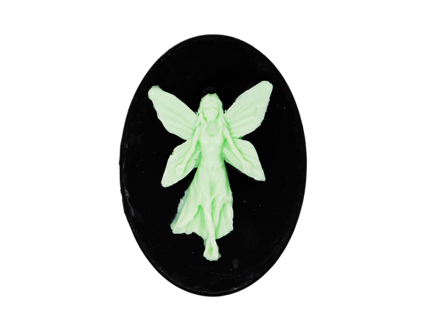 black oval shaped soap with light green fairy on top