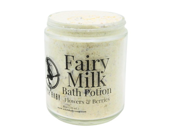 white powdery bath potion full of flowers and salt in an 8 oz glass jar with a label that reads: Fairy Milk Bath Potion. Berries - Flowers - Vanilla..